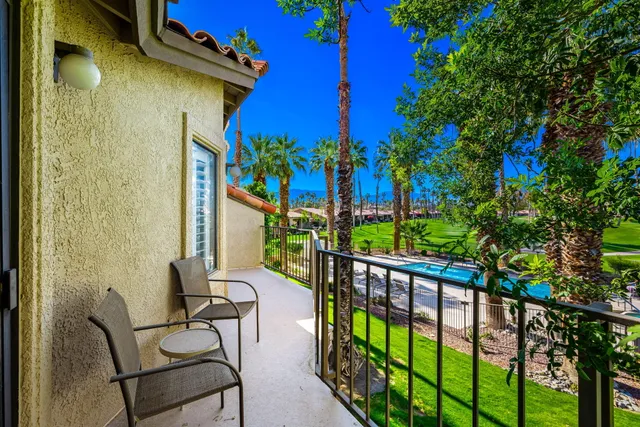 a view of a balcony with chairs
