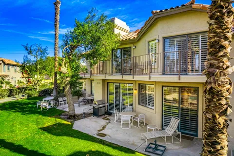 a view of a house with backyard porch and sitting area