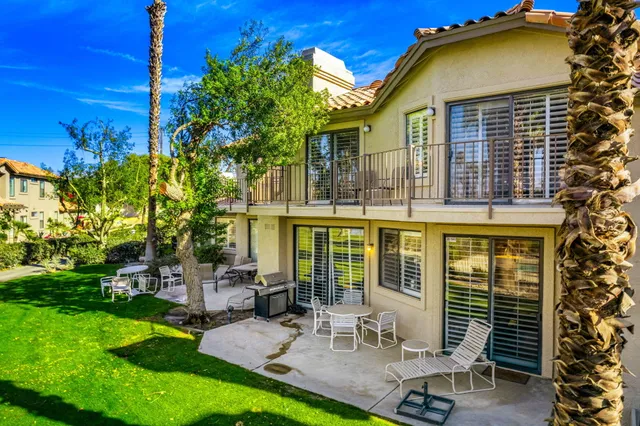 a view of a house with backyard porch and sitting area