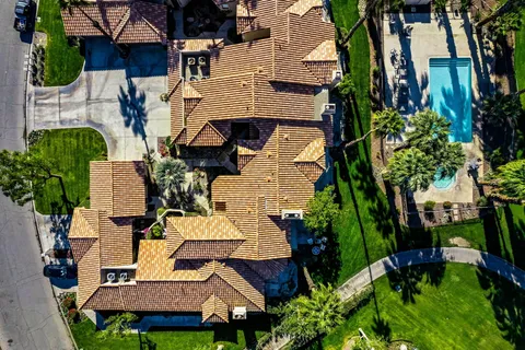 an aerial view of a house with garden space and street view