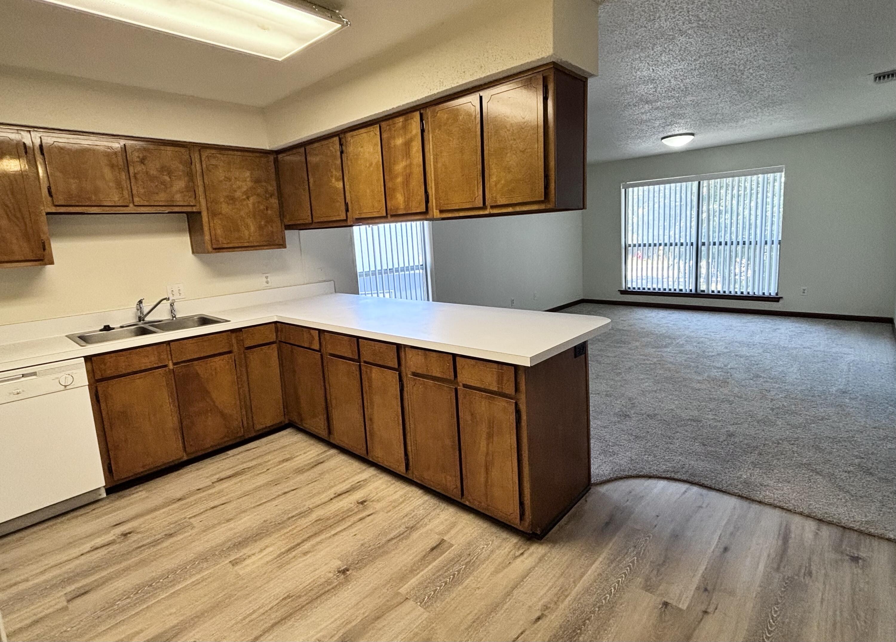 337 Lewis Street, Unit B Fort Walton Beach, FL 32547 - Photo 3 of 8 a kitchen with stainless steel appliances granite countertop a sink a stove cabinets and wooden floor
