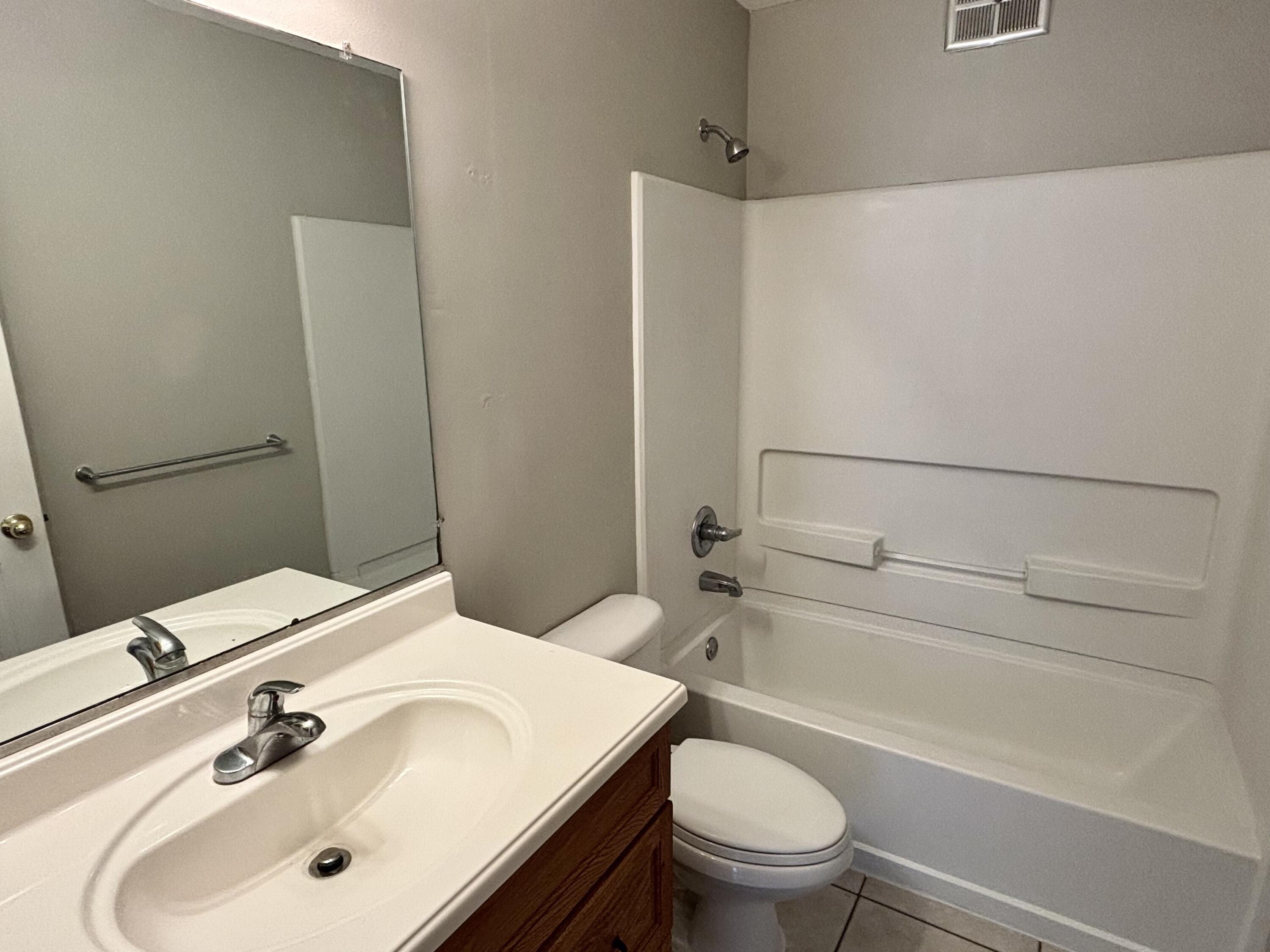 337 Lewis Street, Unit B Fort Walton Beach, FL 32547 - Photo 8 of 8 a bathroom with a sink toilet and shower