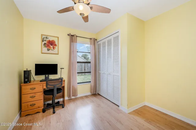 a view of a bedroom with workspace and a window