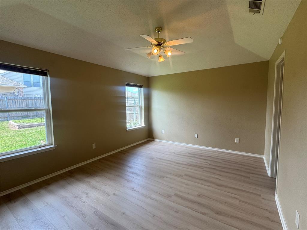 908 Cedar Ridge Lane Burleson, TX 76028 - Photo 11 of 24 a view of an empty room with a window and wooden floor