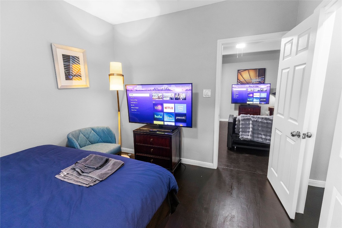 2824 Blodgett Street, Unit 2 Houston, TX 77004 - Photo 17 of 25 a bedroom with furniture and a flat screen tv