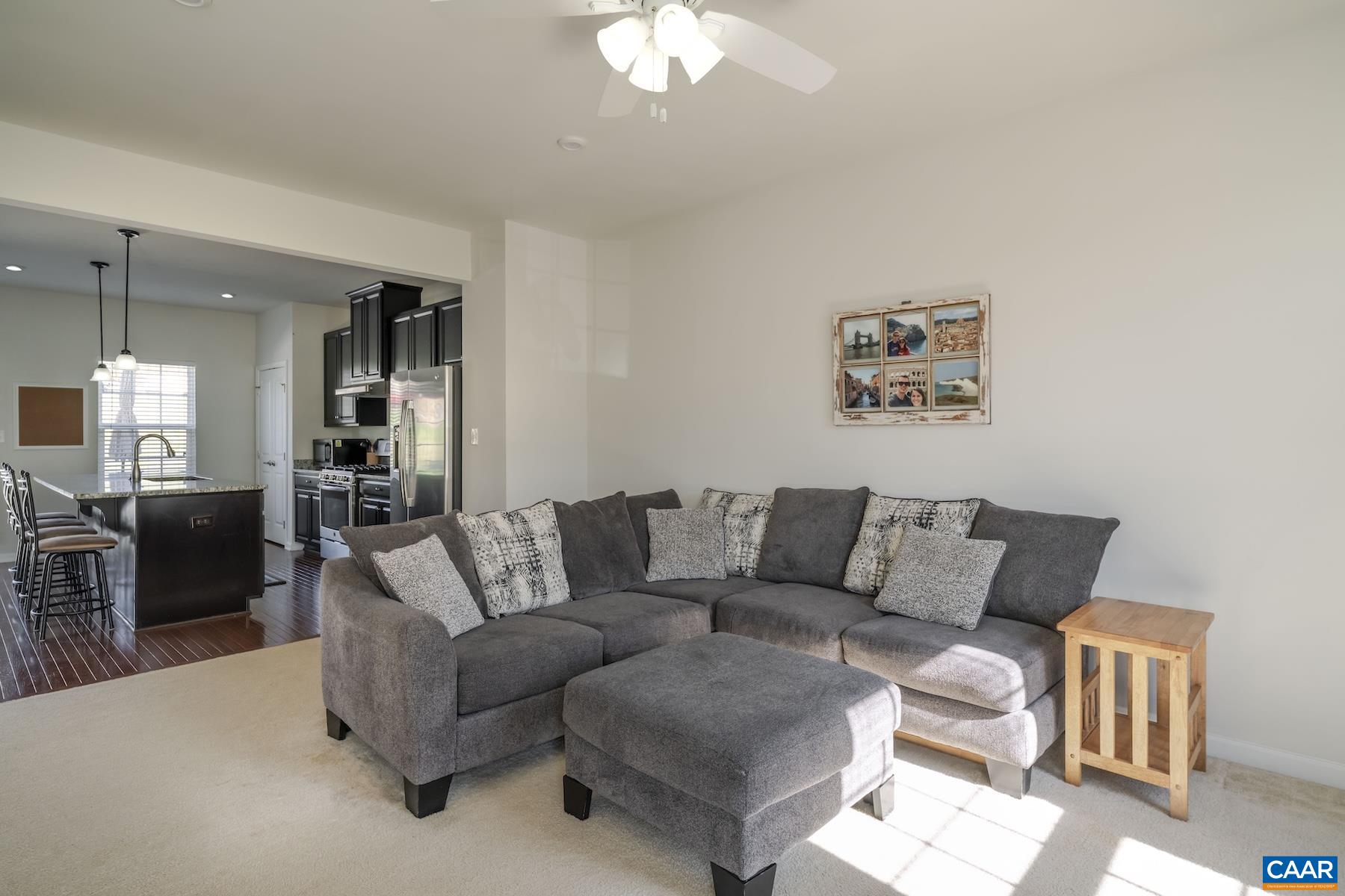 2052 Elm Tree Court Charlottesville, VA 22911 - Photo 5 of 26 a living room with furniture and a chandelier