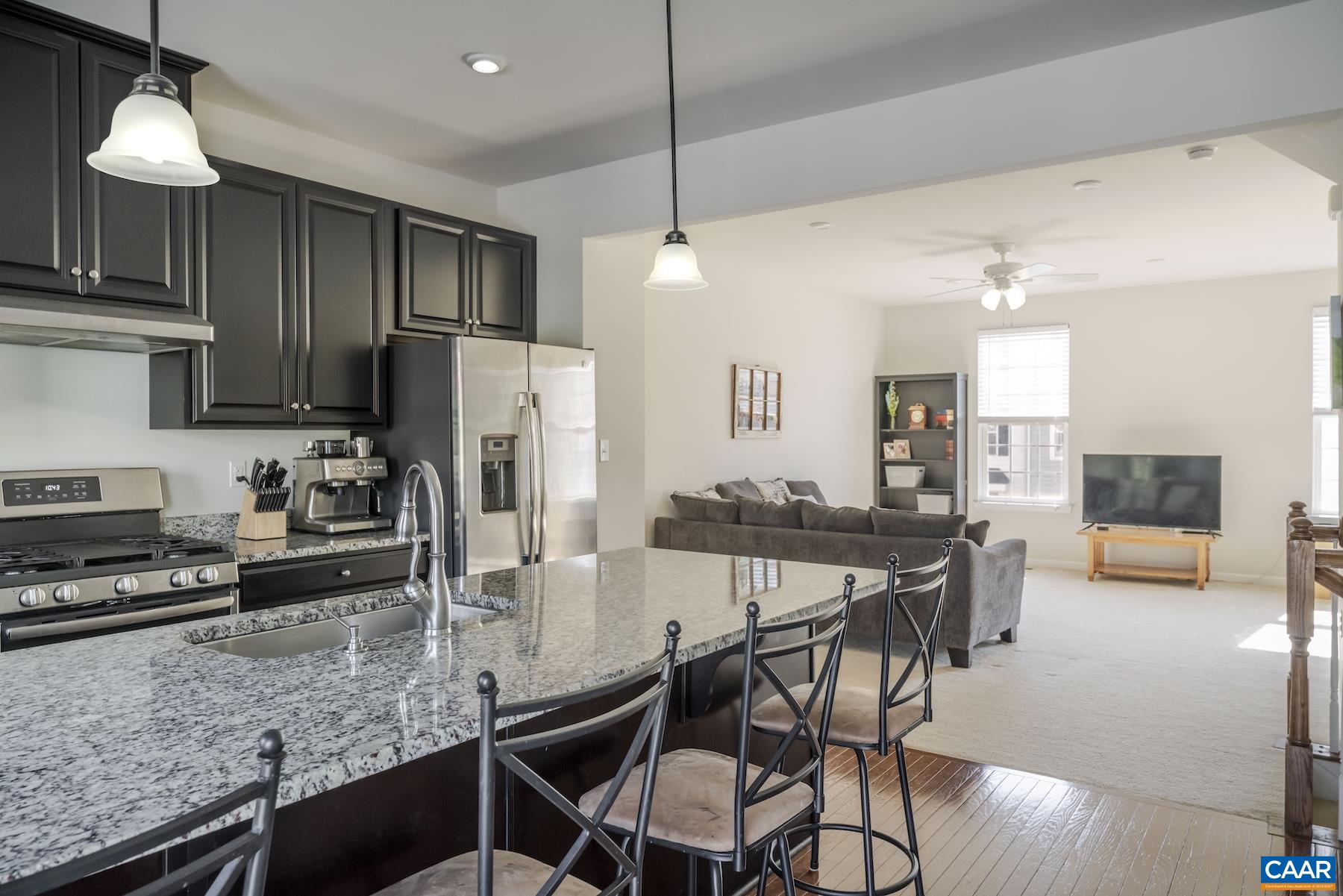 2052 Elm Tree Court Charlottesville, VA 22911 - Photo 6 of 26 a kitchen with stainless steel appliances granite countertop a stove a refrigerator a oven a sink with a dining table and chairs