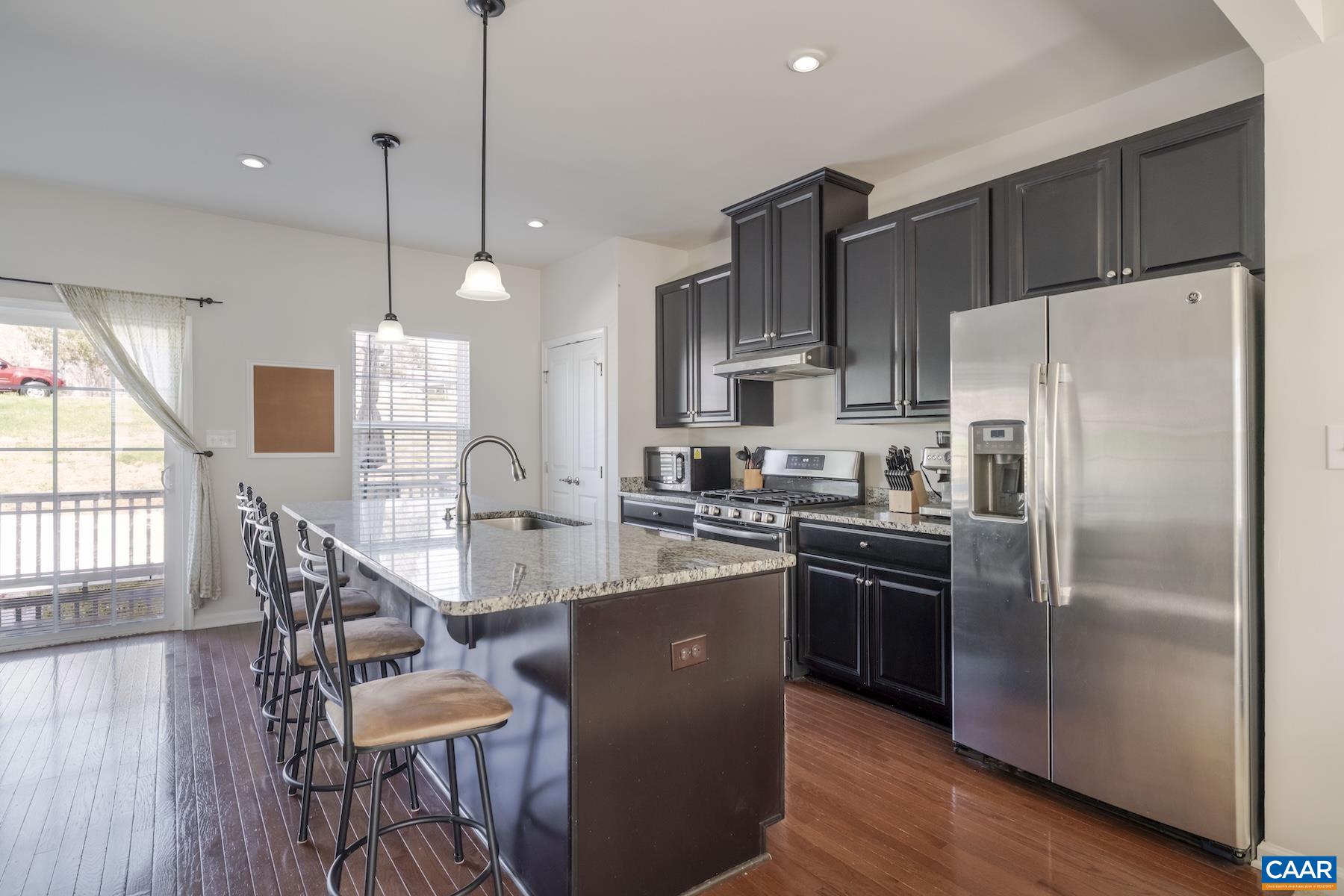 2052 Elm Tree Court Charlottesville, VA 22911 - Photo 8 of 26 a kitchen with stainless steel appliances granite countertop a refrigerator a sink a stove a dining table and chairs