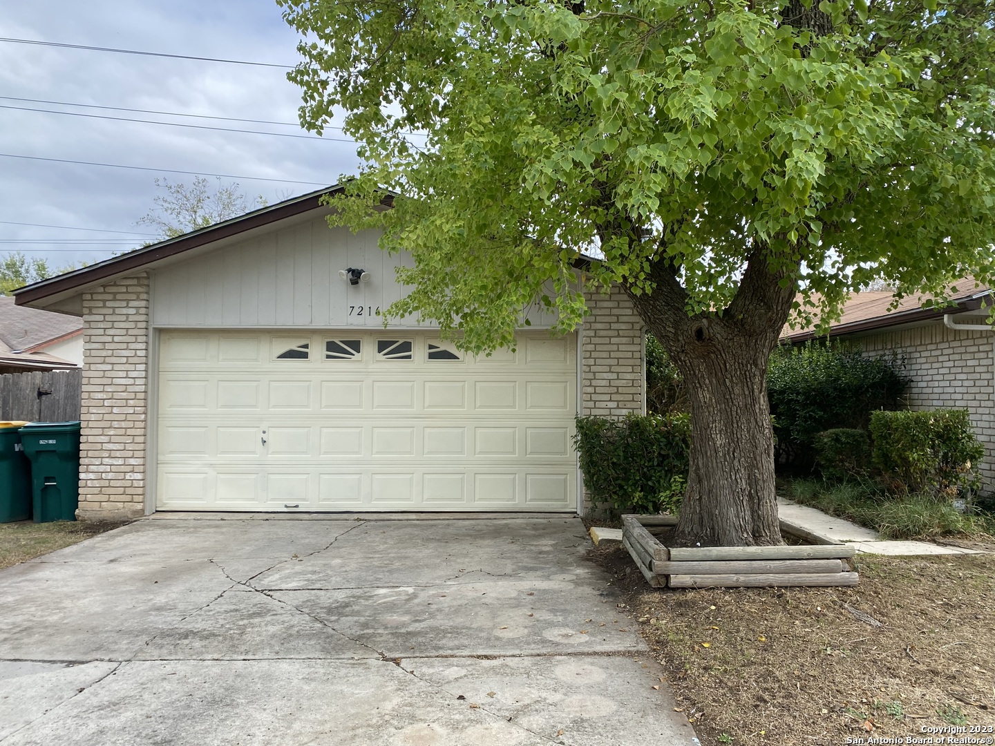 7214 Rimwood Street Live Oak, TX 78233 - Photo 1 of 24 a house with a tree in front of it