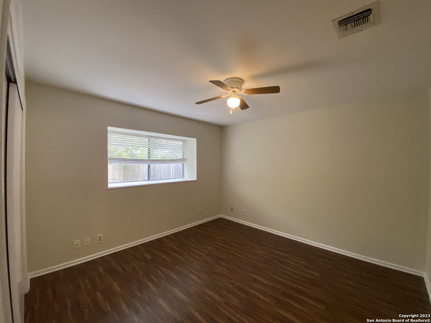 7214 Rimwood Street Live Oak, TX 78233 - Photo 14 of 24 wooden floor in an empty room with a window