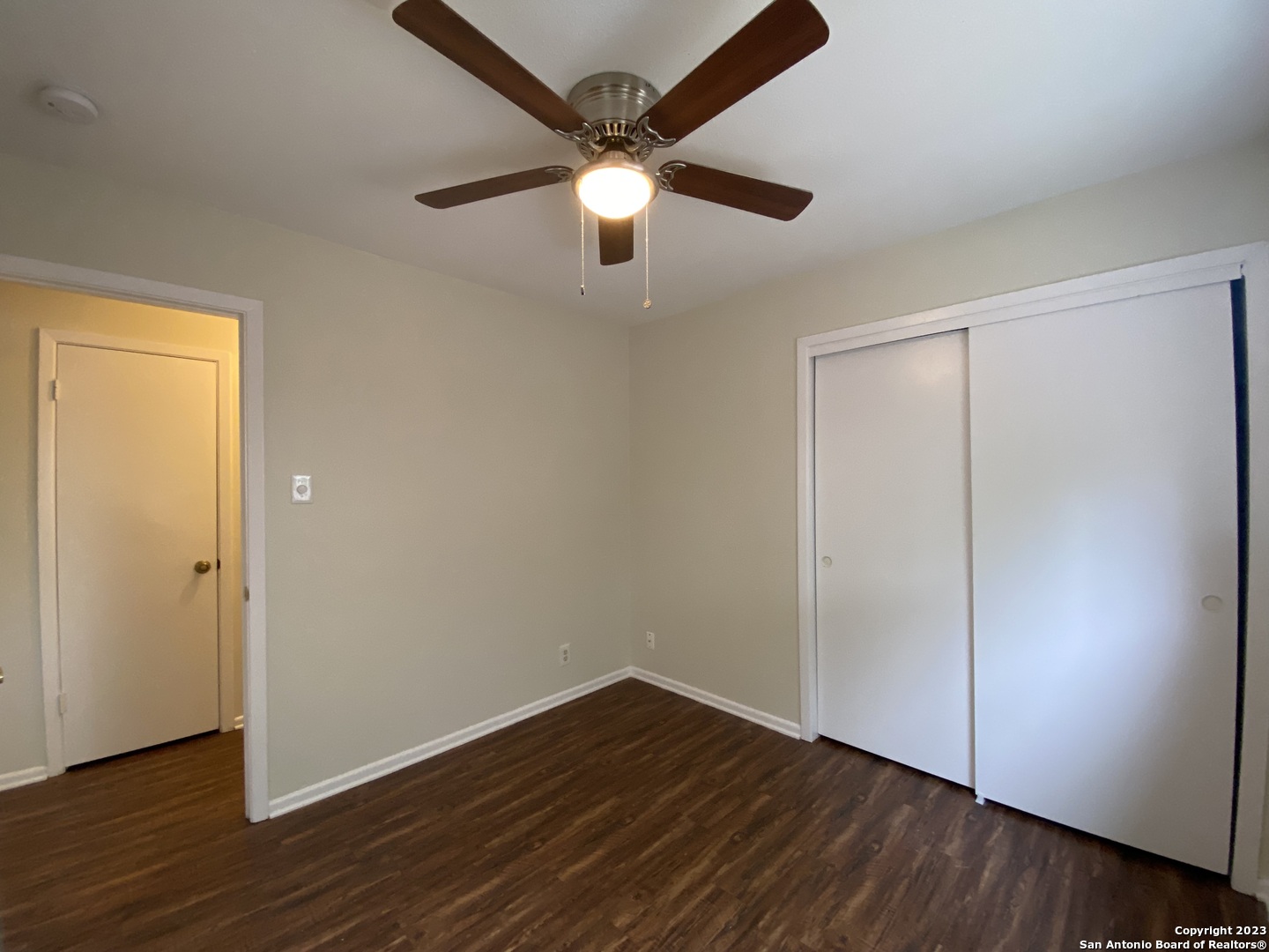 7214 Rimwood Street Live Oak, TX 78233 - Photo 15 of 24 a view of an empty room with wooden floor