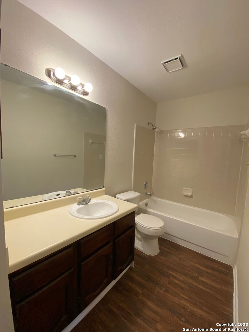 7214 Rimwood Street Live Oak, TX 78233 - Photo 20 of 24 a bathroom with a double vanity sink and a mirror