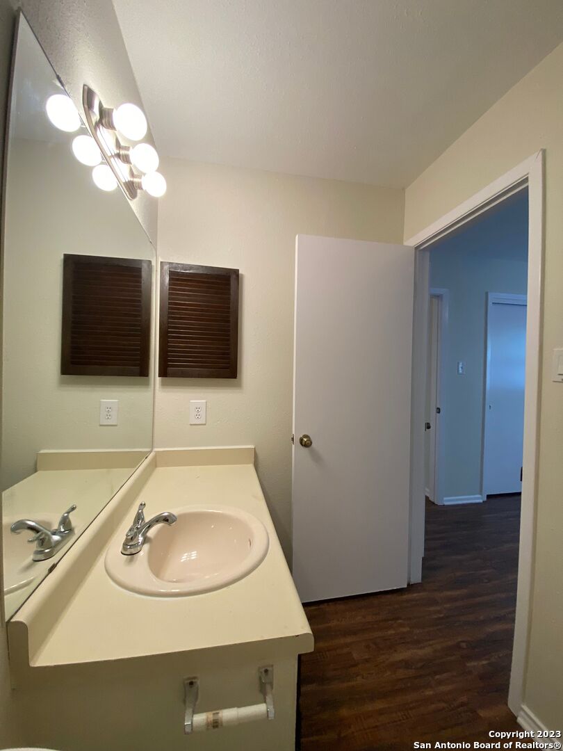 7214 Rimwood Street Live Oak, TX 78233 - Photo 21 of 24 a bathroom with a sink and a mirror