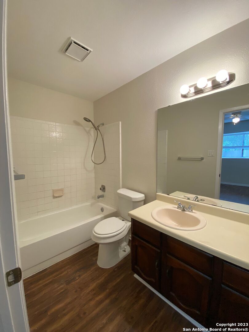 7214 Rimwood Street Live Oak, TX 78233 - Photo 22 of 24 a bathroom with a sink a toilet and shower