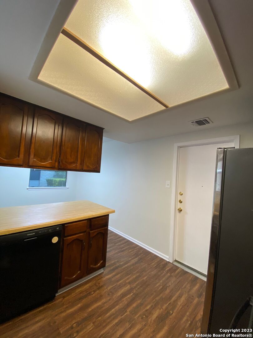 7214 Rimwood Street Live Oak, TX 78233 - Photo 8 of 24 a room with stainless steel appliances wooden floor and view living room