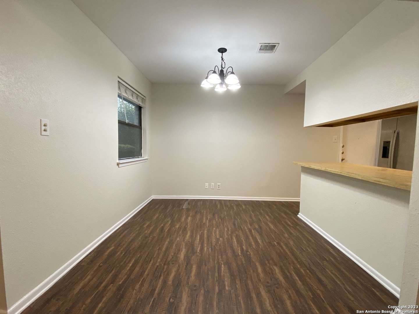 7214 Rimwood Street Live Oak, TX 78233 - Photo 10 of 24 wooden floor in an empty room with a window