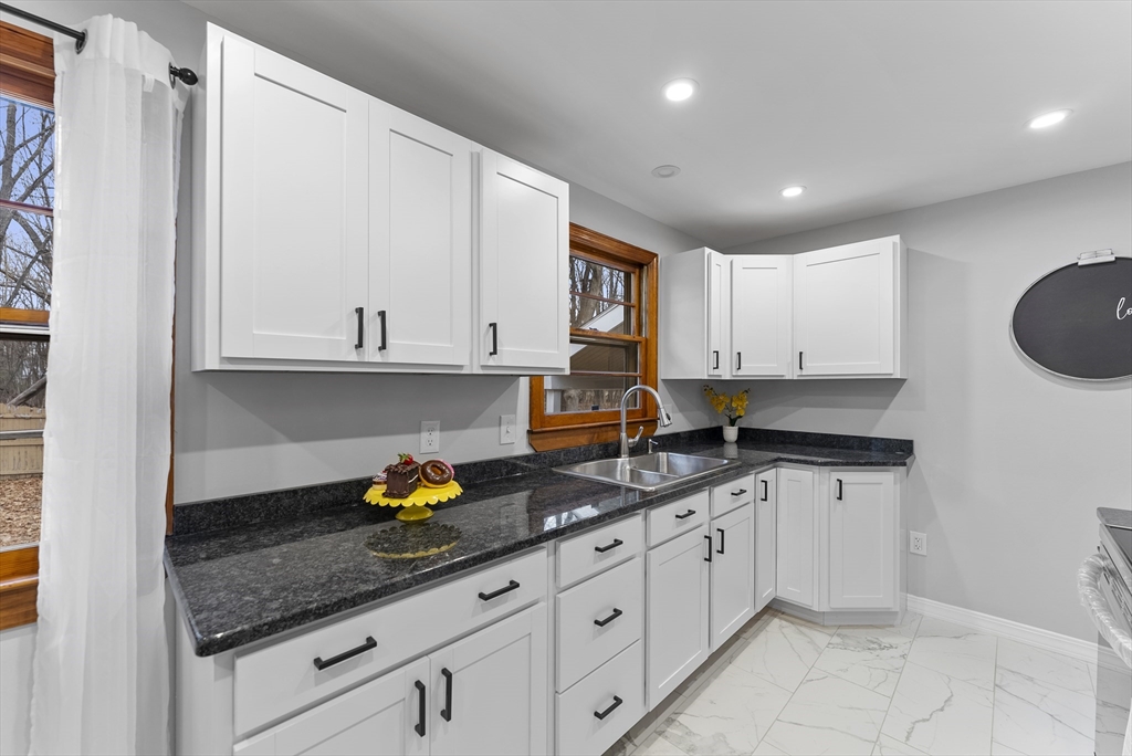 73 Herrman Street West Springfield, MA 01089 - Photo 6 of 38 a kitchen with stainless steel appliances granite countertop a sink a stove and a granite counter tops