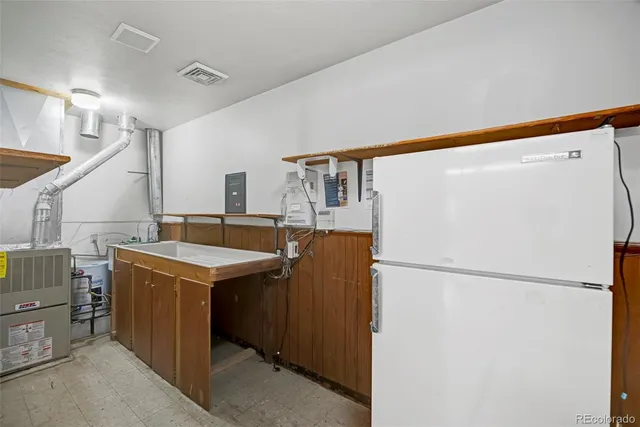 a front view of a house with a garden and trees