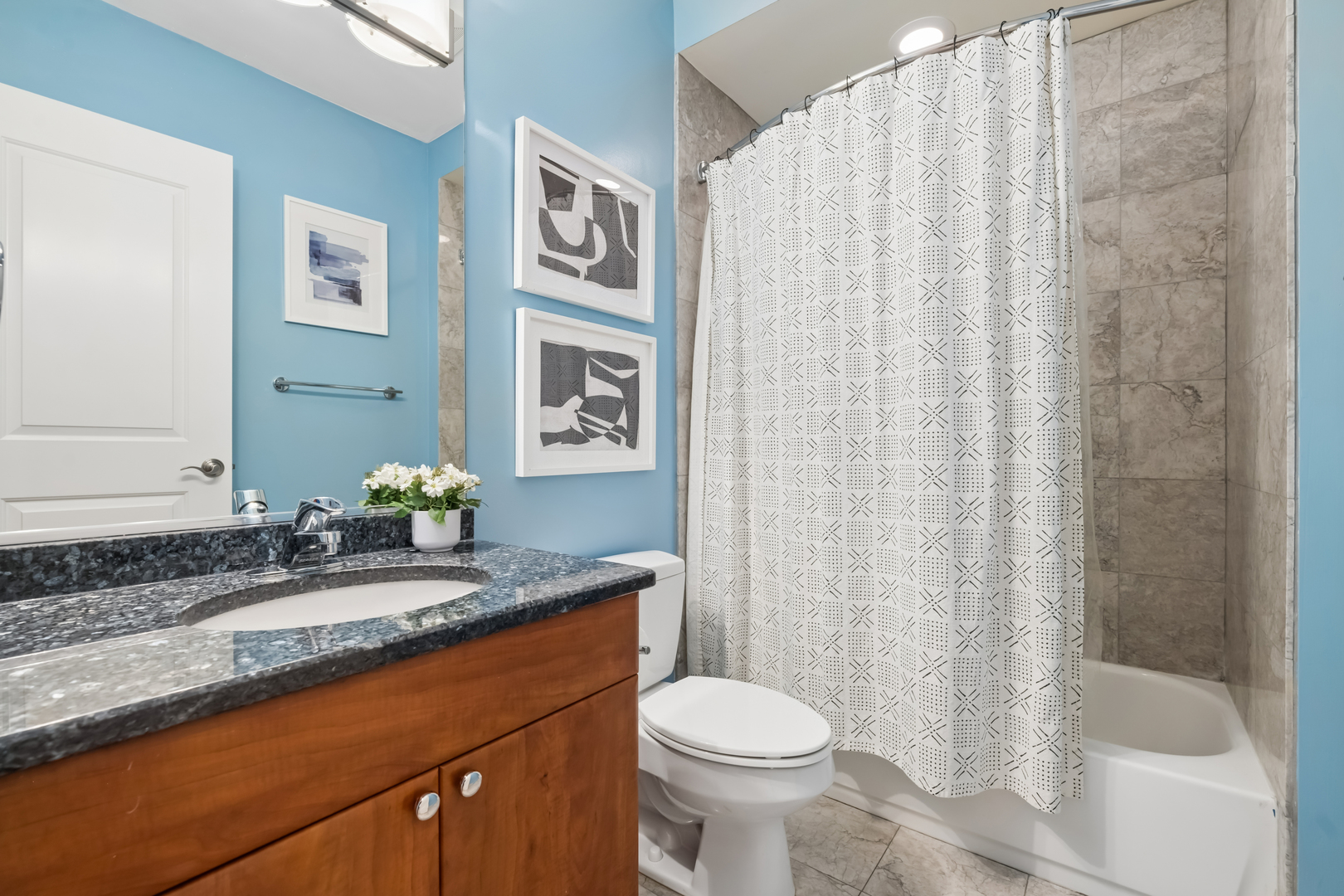 2547 North Clark Street, Unit 2N Chicago, IL 60614 - Photo 23 of 25 a bathroom with a granite countertop sink and a mirror