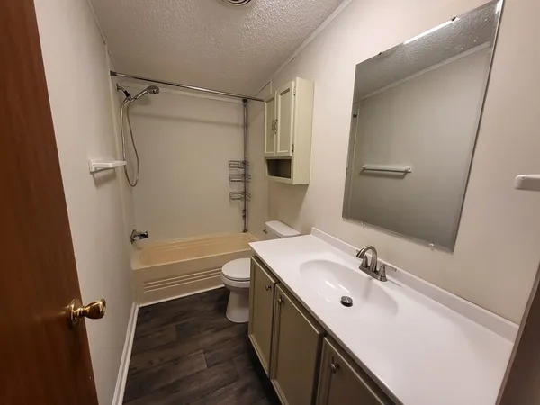 a bathroom with a sink toilet tub and shower
