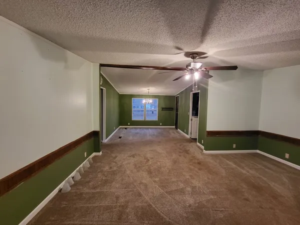 a view of a livingroom with a ceiling fan and window