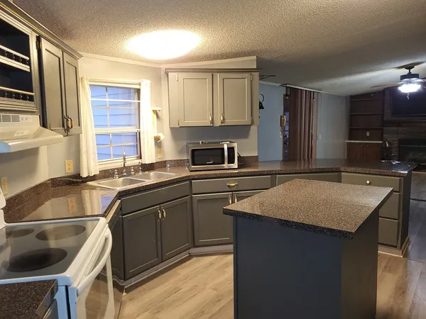 a kitchen with a sink stove and cabinets