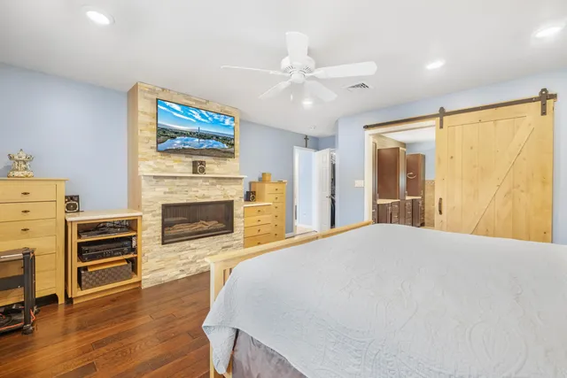 a bedroom with a bed and a television