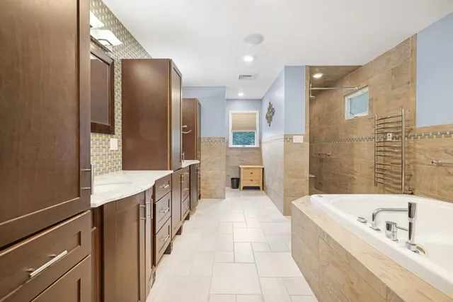 a bathroom with a bathtub and a sink