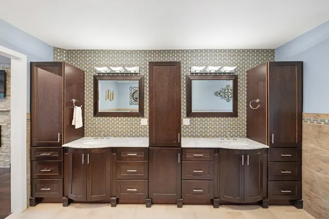 a bathroom with a granite countertop sink and a large mirror