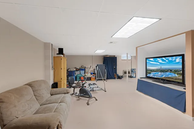a livingroom with furniture and a flat screen tv