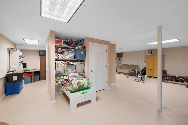 a room with furniture and a kitchen view