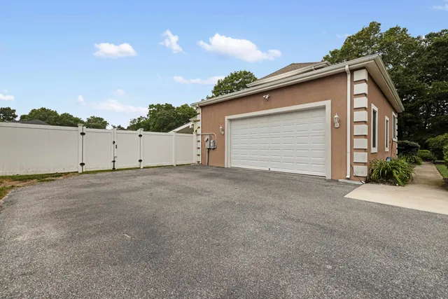a view of garage yard and deck