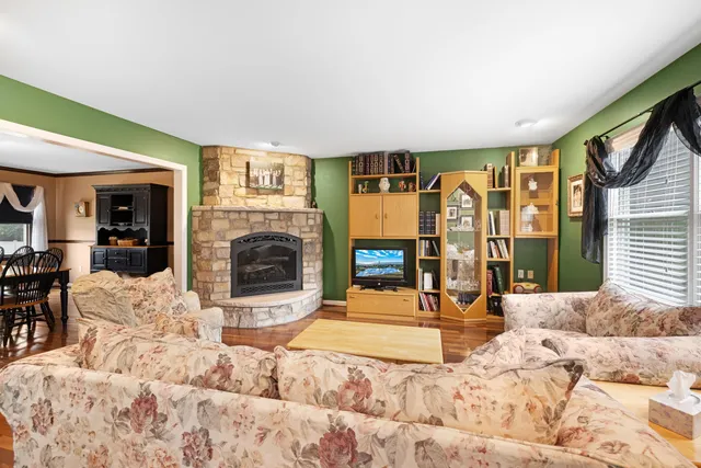 a view of a livingroom with furniture and a fireplace
