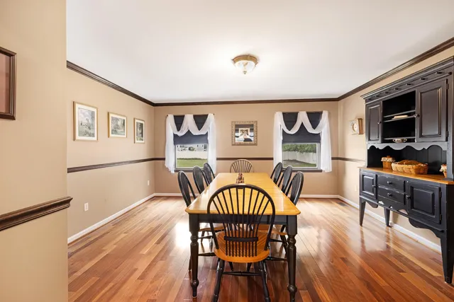 a dining room with furniture a window and wooden floor