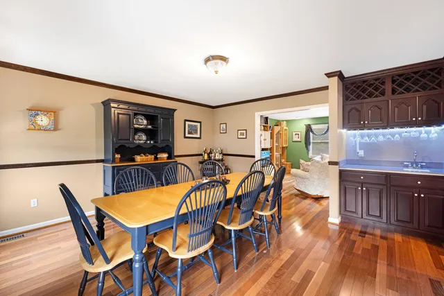 a view of a dining room with furniture and wooden floor