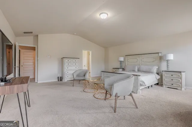 a bed room with furniture and a flat screen tv