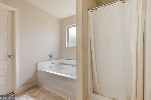a white bath tub sitting next to a white sink