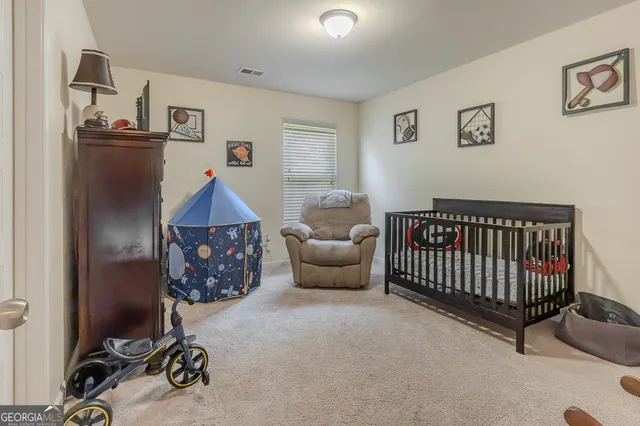 a bedroom with furniture and a window
