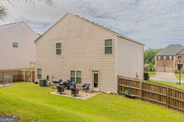 a view of a house with swimming pool and sitting area