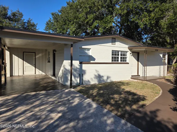 a view of a small house with a yard