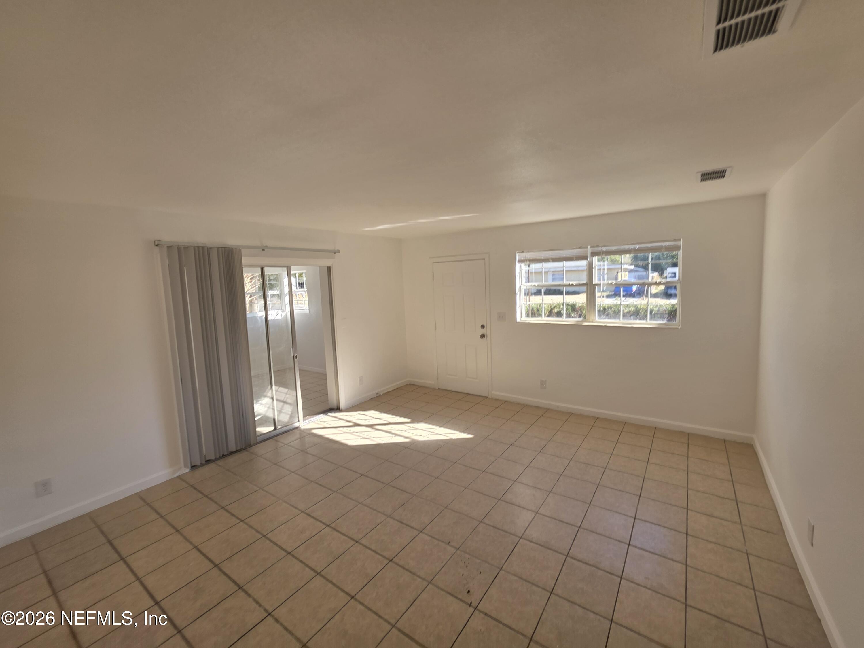 1938 Leon Road Jacksonville, FL 32246 - Photo 3 of 10 a view of an empty room with windows