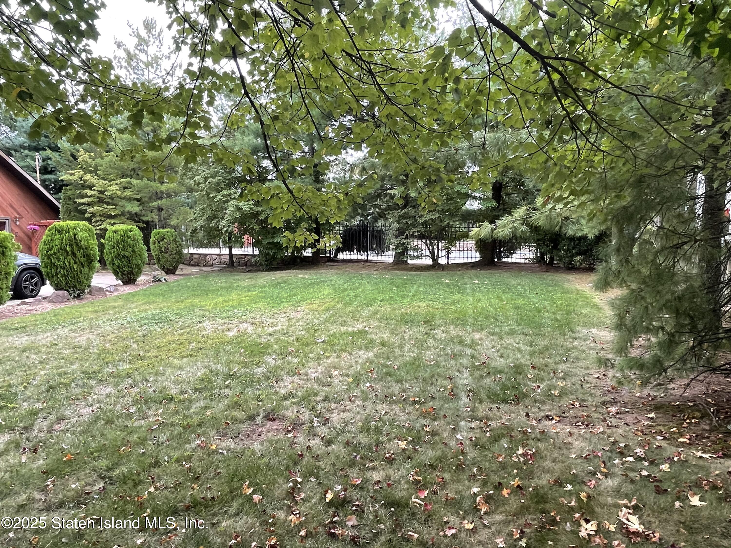 30 Paradise Place Staten Island, NY 10307 - Photo 9 of 15 a view of a big yard with plants and large trees