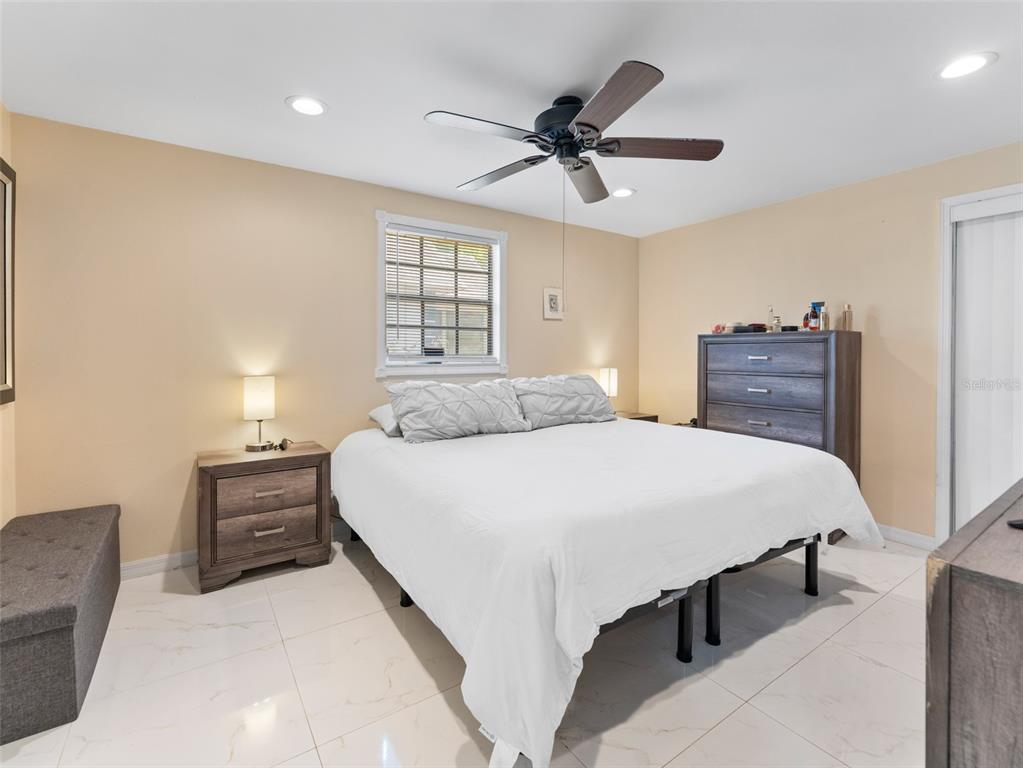 4237 Redcliff Place New Port Richey, FL 34652 - Photo 16 of 25 a bedroom with a bed and window