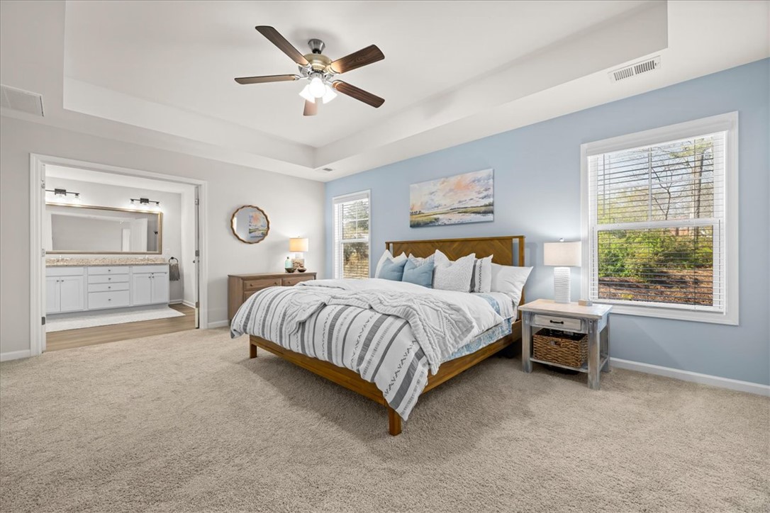 216 Carvel Trail Seneca, SC 29678 - Photo 5 of 46 This spacious primary bedroom features a private bathroom, carpet flooring, and ample natural light.