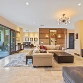 a living room with furniture large window and a flat screen tv