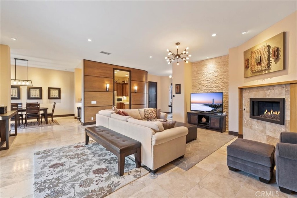 35678 Tranquil Place Cathedral City, CA 92234 - Photo 28 of 75 a living room with furniture a fireplace and a flat screen tv