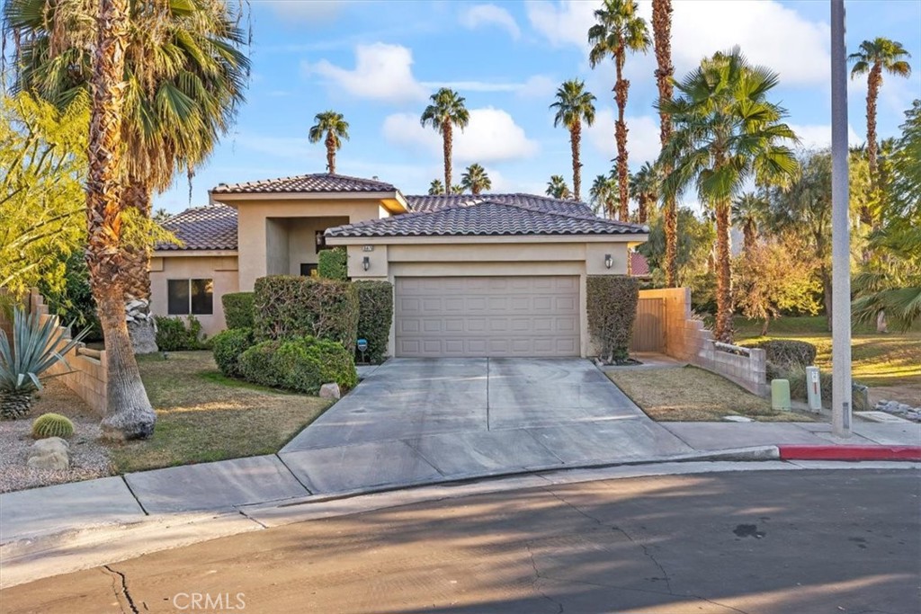 35678 Tranquil Place Cathedral City, CA 92234 - Photo 3 of 75 a view of a house with a yard and palm trees