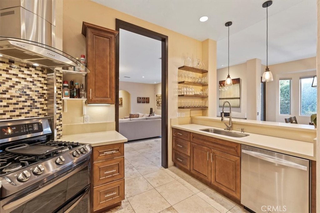 35678 Tranquil Place Cathedral City, CA 92234 - Photo 35 of 75 a kitchen with stainless steel appliances granite countertop a stove a sink and a refrigerator