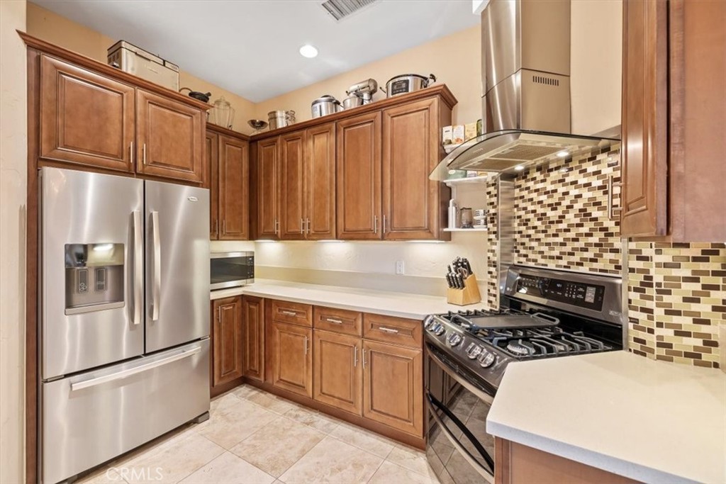 35678 Tranquil Place Cathedral City, CA 92234 - Photo 36 of 75 a kitchen with stainless steel appliances granite countertop a refrigerator and a stove