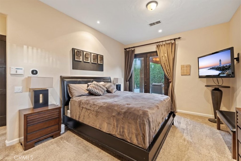 35678 Tranquil Place Cathedral City, CA 92234 - Photo 43 of 75 a bedroom with a bed and a flat screen tv